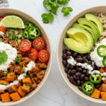 High Protein Sweet Potato Taco Bowl Easy Recipe 16 Overhead view of a high-protein sweet potato taco bowl with black beans, sliced avocado, fresh jalapeños, cherry tomatoes, and a creamy dressing